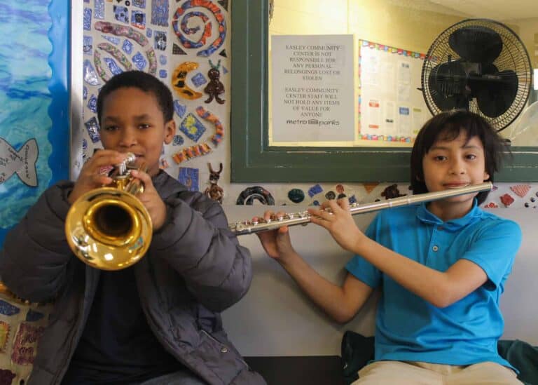 Two boys playing a trumpet and a clarinet