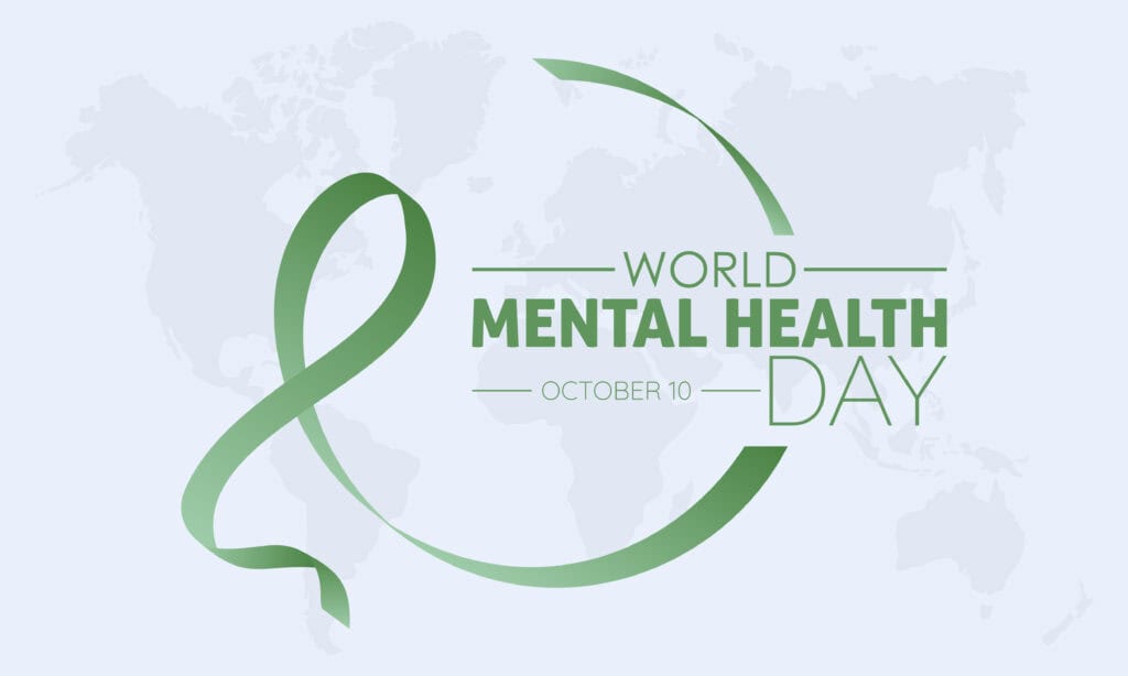 Green ribbon forming a circle with the text World Mental Health Day, October 10 on a light background with a faint world map.