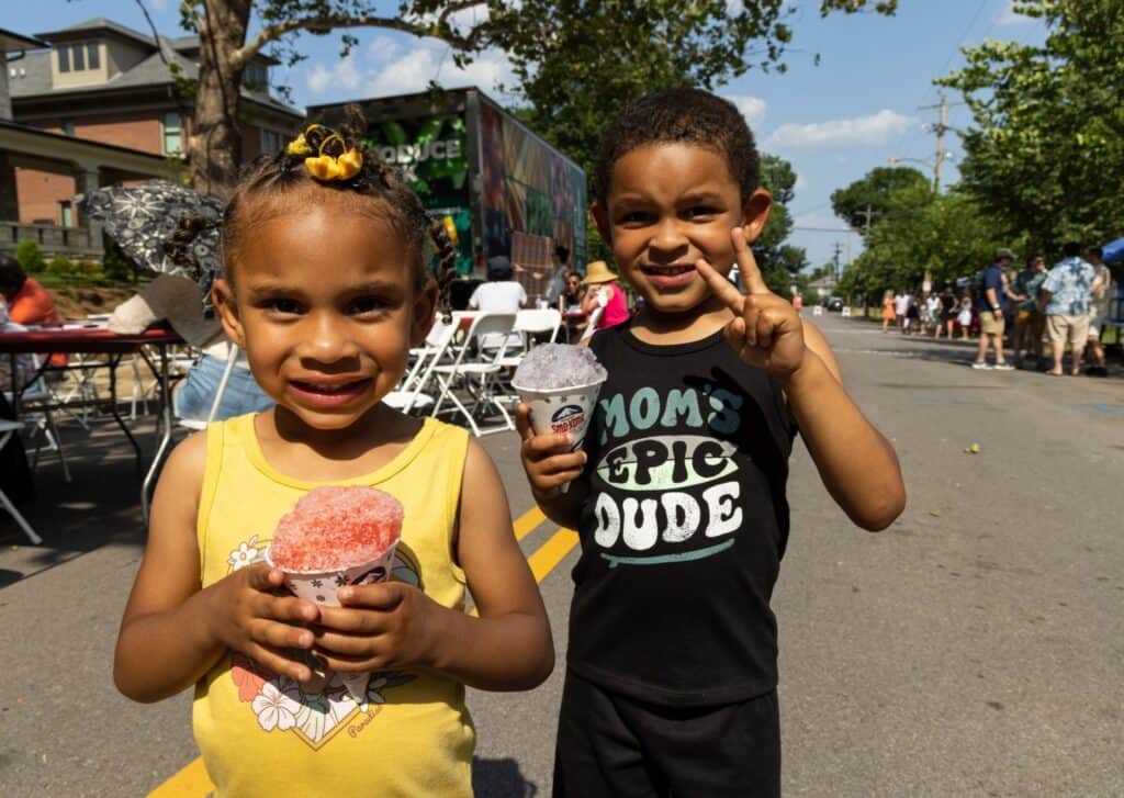 Two smiling kids with snow cones