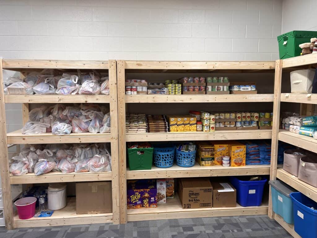 How BJ’s Wholesale Club Middle Tennessee Fights Hunger: stocked school pantry shelves filled with groceries and ready-to-go food bags for local families.