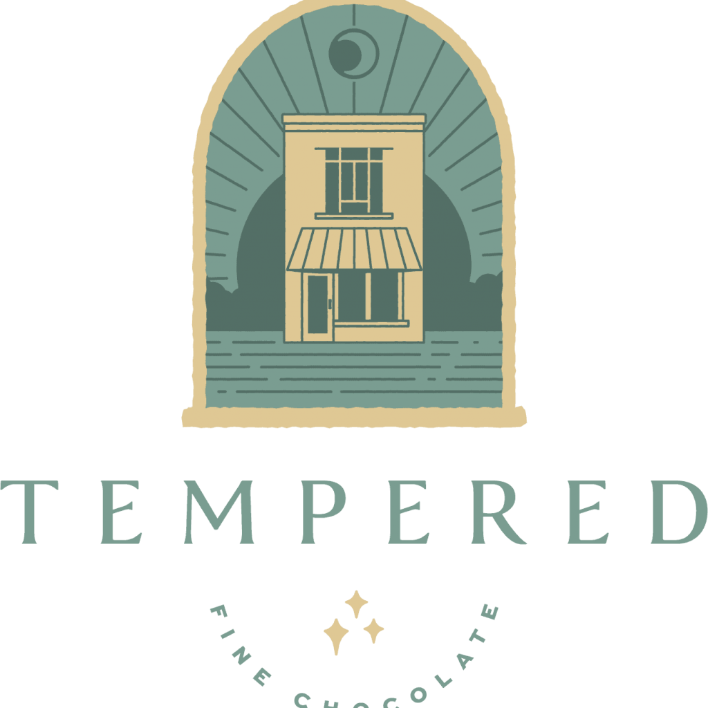 A logo featuring a stylized storefront inside an arch with a rising sun. Below, the word “TEMPERED” appears in large letters; underneath, “FINE CHOCOLATE” is written in smaller text with three small sparkling stars.